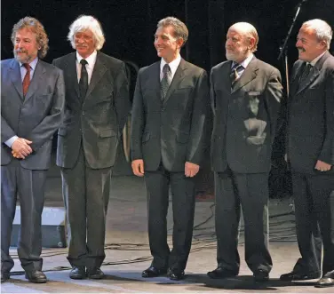  ?? JUAN MABROMATA / AFP ?? In this file photo taken on August 8, 2007, members of the ‘Les Luthiers’ music ensemble members pose for a photograph: (left to right) Carlos Núñez Cortés, Carlos López Puccio, Jorge Maronna, Marcos Mundstock and Daniel Rabinovich wait to be decorated by then-spanish Vice-president María Teresa Fernández de la Vega with the “Encomienda de Número de la Orden de Isabel la Católica” order in Buenos Aires.