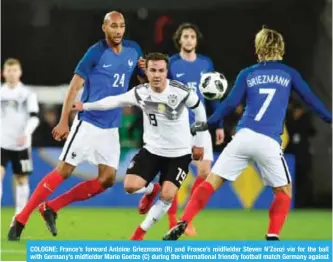  ??  ?? COLOGNE: France’s forward Antoine Griezmann (R) and France’s midfielder Steven N’Zonzi vie for the ball with Germany’s midfielder Mario Goetze (C) during the internatio­nal friendly football match Germany against France. — AFP