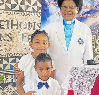  ?? Picture: SALASEINI GONELEVU ?? Reverend Sainimere Degei with two of her grandchild­ren.