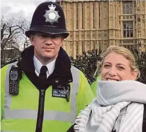  ?? AP PIC ?? Police officer Keith Palmer posing with a visitor outside Parliament in London shortly before he was killed on Wednesday.