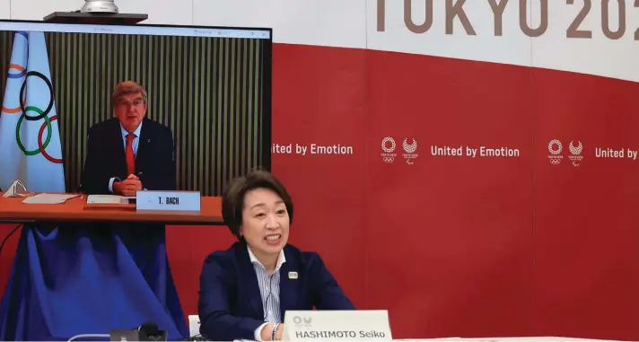  ??  ?? Internatio­nal Olympic Committee (IOC) President Thomas Bach, on a screen, delivers an opening speech while Tokyo 2020 Organizing Committee President Seiko Hashimoto listens at a five-party meeting of Tokyo 2020