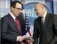  ?? THE ASSOCIATED PRESS ?? National Economic Director Gary Cohn, right, yields the podium to Treasury Secretary Steve Mnuchin in the briefing room of the White House in Washington on Wednesday, where they discussed President Donald Trump tax proposals.