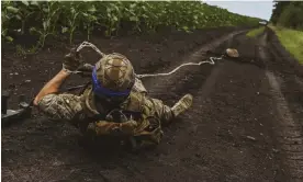  ?? ?? A member of Ukraine’s 35th Marine Brigade conducts mine clearance work in Donetsk. Photograph: Anadolu Agency/Getty Images