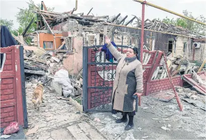  ?? I
AFP ?? Una mujer señala su casa destruida por un bombardeo ruso en Donetsk.