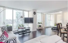  ??  ?? This two-bedroom apartment at 1705 — 1009 Expo Blvd. in Vancouver has an open concept layout with laminate floors. It sold for $1,098,000 after six days on the market.