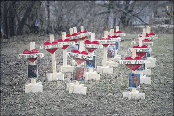  ?? SCOTT OLSON / GETTY IMAGES ?? Crosses sit in a vacant lot Monday in the Englewood neighborho­od in Chicago. Each cross, created by Greg Zanis, represents a victim of murder in Chicago in 2017. This January has seen several violent weekends in the city.