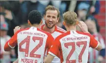  ?? REUTERS ?? Harry Kane is congratula­ted by Bayern Munich teammates Jamal Musiala and Konrad Laimer after completing his hat-trick in an 8-1 Bundesliga rout of Mainz on Saturday.