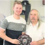  ??  ?? Jake Selby who scored the most maximums in Division One being presented with his trophy by LDPCDL committee member John Monk.