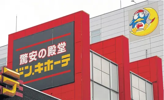  ?? PHOTOS BY REUTERS ?? The logo of Japanese discount retailer Don Quijote Holdings Co Ltd is pictured at one of its stores in Tokyo.