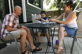  ?? Helen H. Richardson, The Denver Post ?? Chris Paskoff and his wife, Tracy, work on a science project with their son, Hayes, 6, in their backyard on July 1 in Arvada.