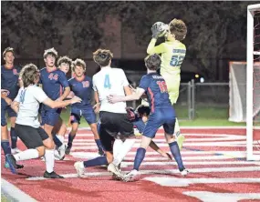 ?? CHET PETERMAN/SPECIAL TO THE POST ?? Oxbridge’s Remi DeOrsey leaps above the other players to secure a shot into the box during his team’s regional quarterfin­als victory over St. John Paul II on Tuesday.