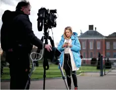  ?? ?? A journalist gets ready to report from outside Kensington Palace.