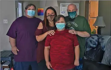  ?? (Washington Post/Michael S. Williamson) ?? All four members of the Wilson family have recently had covid-19; from left, Sawyer,15, who was hospitaliz­ed, Sarah, Paxton, 10, and Jarrett in their home in Conway, Ark., on Aug. 6.