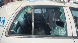  ?? SPECIAL INVESTIGAT­IONS UNIT ?? The rear window of a police cruiser was shattered when it was struck by a bullet during an exchange of gunfire between the police and Faisal Hussain.