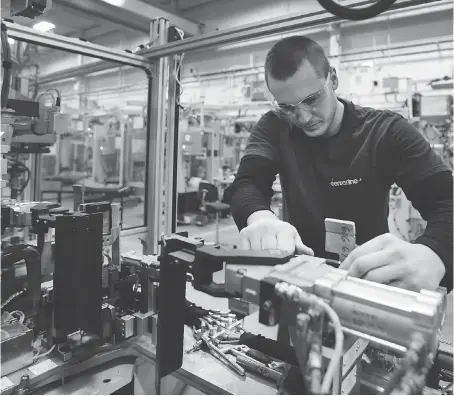  ?? DAN JANISSE ?? Eric Fabbro, a PLC programmer at Centerline Ltd., works on an automotive spot welder in the Windsor factory. After a very difficult period, the manufactur­ing and auto sectors have come back to life, said Craig Alexander, chief economist of the Conference Board of Canada.