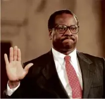  ?? J. DAVID AKE/AFP/GETTY IMAGES ?? Clarence Thomas was sworn in during his confirmati­on hearings to join the Supreme Court in 1991.