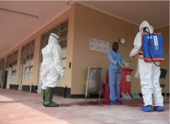  ??  ?? A nurse has her hands sprayed with disinfecta­nt at the Wilkins Hospital in Harare, Zimbabwe’s main COVID-19 isolation and treatment center, on April 9. The hospital was revamped with funds from the Chinese business community in the country