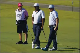  ?? PHOTOS BY DAVID J. PHILLIP — AP PHOTO ?? From right, Zac Blair, Harold Varner III and caddie Rick Wynn observe a moment of silence to pay their respects to the memory of George Floyd on the 16th hole during the second round of the Charles Schwab Challenge golf tournament at the Colonial Country Club in Fort Worth, Texas.