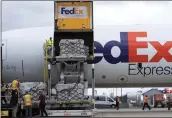  ?? JOSE LUIS MAGANA — THE ASSOCIATED PRESS ?? Workers unload a Fedex Express cargo plane carrying 100,000pounds of baby formula at Washington Dulles Internatio­nal Airport in Chantilly, Va., on Wednesday.