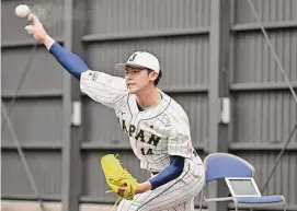  ?? Associated Press ?? Japanese pitcher Roki Sasaki throws a ball during camp at theWorld Baseball Classic, in Miyazaki, southern Japan, on Feb. 19.