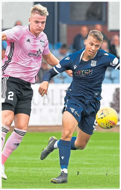  ??  ?? Dark Blues striker Andrew Nelson battles with the Blue Toon’s Jason Brown.