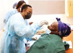  ?? ?? Health and Childcare Ambassador, First Lady Dr Auxillia Mnangagwa conducts first eye dressing on Gogo Esteri Zvirahwa from Nyanga after eye cataract surgery at Sekuru Kaguvi eye unit last year.