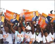  ??  ?? Supporters of presidenti­al candidate Alassane Ouattara of the ruling RHDP coalition party hold signs during a campaign rally for the October 31 presidenti­al election, in Abidjan, yesterday.