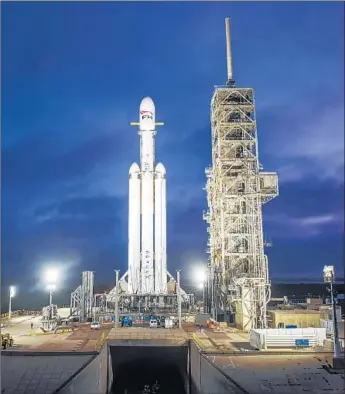  ?? SpaceX ?? A FALCON Heavy rocket sits in Cape Canaveral, Fla., in December. The 27-engine rocket will launch from Kennedy Space Center in its first demonstrat­ion mission carrying SpaceX CEO Elon Musk’s Tesla.