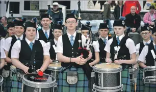  ??  ?? Award winners Emilli Donoghue, left, Ewan McGregor, centre, and Rachael Fraser, right, surrounded by band members in Cameron Square during the final street parade of the summer.