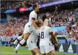  ?? ELSA/GETTY IMAGES/TNS ?? Megan Rapinoe of the USA celebrates with teammates after scoring her team's first goal of Friday's World Cup quarterfin­al match against France in Paris.