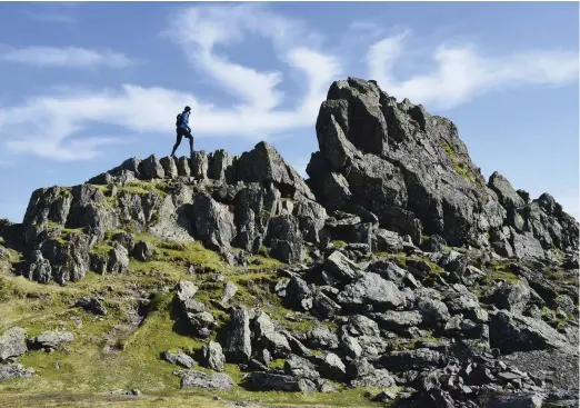  ??  ?? ABOVE James climbs The Howitzer on the summit of Helm Crag, a feat Wainwright never achieved. The 405m fell is one of many high points on Wainwright’s Coast to Coast walk, a journey that includes more than 8,600m of ascent – that’s like climbing Ben Nevis, sea to summit, six times