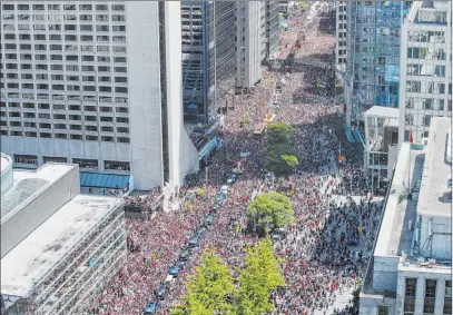  ?? Andrew Lahodynsky­j The Associated Press ?? Fans pack downtown Toronto on Monday for the Toronto Raptors NBA championsh­ip victory parade.