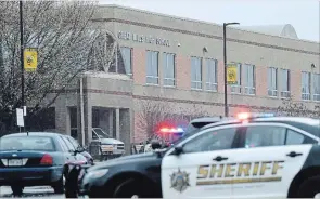  ?? SUSAN WALSH THE ASSOCIATED PRESS ?? Police converge on Great Mills High School, the scene of a shooting, Tuesday in Great Mills, Md. .