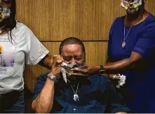  ?? Yi-Chin Lee / Staff photograph­er ?? Olton Guidry, center, and Juana Johnson, at a Wednesday news conference at Crime Stoppers of Houston, are asking the public’s help to find who killed their daughter, Brittany Guidry.