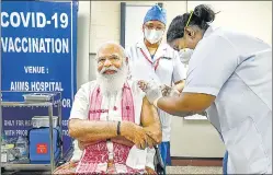  ?? PTI ?? PM Narendra Modi being administer­ed the Covid-19 vaccine, at AIIMS, New Delhi, on Monday.