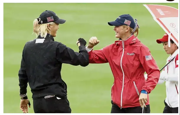  ??  ?? We did it: Jessica Korda (right) and Michelle Wie reacts on the 5th hole during the third round of the Internatio­nal Crown golf tournament at the Jack Nicklaus Golf Club Korea in Incheon, South Korea. yesterday. The third round was stopped midway because of fading light.