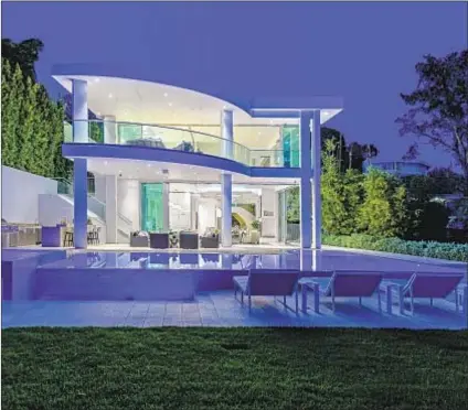  ?? Photograph­s by Aaron Hoffman ?? A DRAMATIC showplace on Magnetic Terrace in Los Angeles has curved walls of glass, a chef ’s kitchen, a salon and a home theater. Outside: a 30,000-gallon infinity-edge swimming pool and spa.