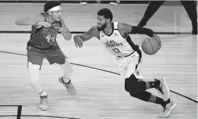  ?? [AP PHOTO/ASHLEY LANDIS, POOL] ?? Los Angeles Clippers' Paul George (13) drives to the basket against Dallas Mavericks' Justin Jackson (44) during the second half of an NBA first round playoff game Tuesday in Lake Buena Vista, Fla.