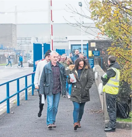  ?? Pictures: Alan Richardson. ?? “A blow for Dundee”: factory workers leave the site after the meeting.