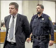  ?? AP/Chicago Tribune/ANTONIO PEREZ ?? Police officer Jason Van Dyke (left) is taken into custody Friday at a courthouse in Chicago after jurors convicted him in the fatal 2014 shooting of black teenager Laquan McDonald in a case that stoked anger across the country and led to a federal inquiry into the Chicago police force.