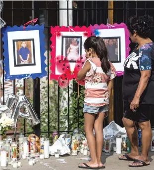  ?? ASHLEE REZIN/SUN-TIMES ?? A memorial sits outside a house near the site of a fire that killed 10 children. The fire broke out in the 2200 block of South Sacramento Avenue in Little Village.