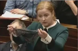  ??  ?? Ruth Coppinger TD holds up a thong in the Dáil in protest at ‘rape myths’.