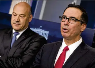  ?? STEPHEN CROWLEY / THE NEW YORK TIMES ?? Treasury Secretary Steven Mnuchin (right) and Gary Cohn, chief economic adviser to President Donald Trump, have key roles in selling Trump’s tax plan to Congress. The plan would cut the top corporate income tax rate from 35 percent to 15 percent.