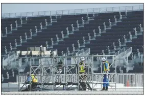  ?? (AP/Eugene Hoshiko) ?? Workers prepare the venue at Kasai Canoe Slalom Centre for the Tokyo 2020 Olympics in Tokyo.