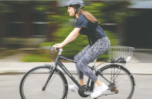  ?? JOHN MAHONEY ?? Psychology post-doctoral fellow Anne Holding rides in her Outremont neighbourh­ood: Whereas some are happy to take on the shift in responsibi­lity from government, “others are apprehensi­ve, with good reason,” she says. “Especially for those who are concerned about the vaccine or those who have health reasons for not taking it, it is a really uncertain time.”