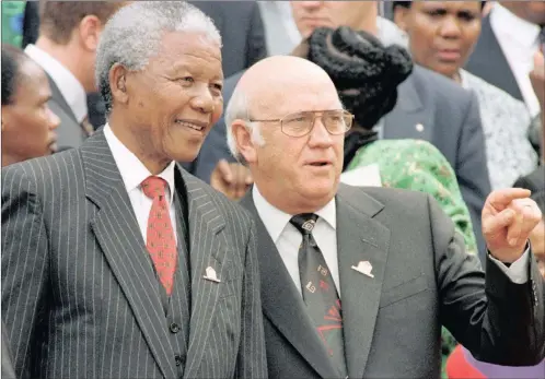  ?? PICTURE: AP ?? Nelson Mandela, left, and then-deputy president FW de Klerk chat outside Parliament after the approval of South Africa’s new constituti­on in 1996. Both men had important choices to make during the transition to democracy, says Gounden.