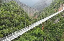  ?? ?? the Bach Long glass bridge in Moc Chau district in Son La province is suspended 150m above a jungle-clad gorge. — AFP