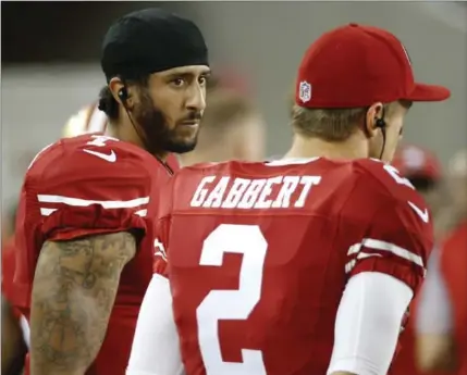  ?? ASSOCIATED PRESS FILE PHOTO ?? San Francisco 49ers QBs Colin Kaepernick and Blaine Gabbert stand on the sideline during the second half of an NFL pre-season game against the Green Bay Packers on Friday in Santa Clara, Calif. Kaepernick refused to stand for the national anthem to...