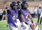  ?? KYLE TELECHAN / POST-TRIBUNE ?? Merrillvil­le’s Lavarion Logan, right, and Adonis Rodgers celebrate after Logan scored a touchdown.