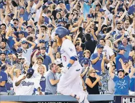  ?? Wally Skalij Los Angeles Times ?? DODGERS FANS go wild after Justin Turner’s game-winning three-run homer against the Chicago Cubs in Game 2 of the National League Championsh­ip Series.
